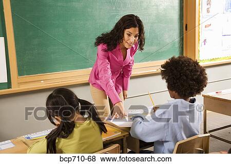 Female teacher helping student View Large Photo Image Stock Photo - Female teacher helping student. Fotosearch