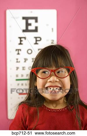 Girl wearing eyeglasses in front of eye chart View Large Photo Image Stock Image - Girl wearing eyeglasses in front of eye chart. Fotosearch