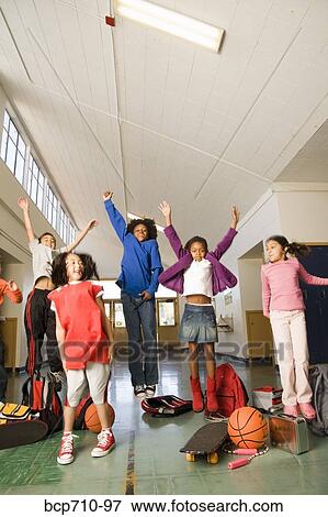Group of students cheering in hallway View Large Photo Image Stock Photo - Group of students cheering in hallway. Fotosearch