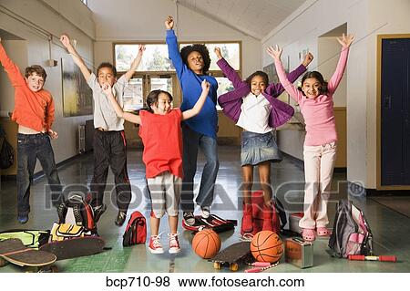 Group of students cheering in hallway View Large Photo Image Stock Photo - Group of students cheering in hallway. Fotosearch