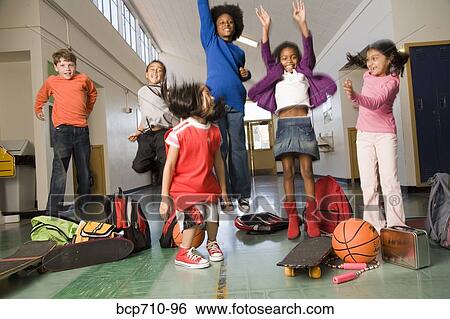 Stock Photograph - Group of students cheering in hallway. Fotosearch