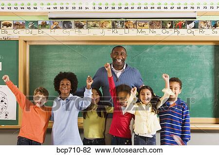 Male teacher and students cheering in classroom View Large Photo Image Stock Image - Male teacher and students cheering in classroom. Fotosearch