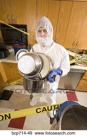 Man wearing coveralls and holding pots in dirty kitchen View Large Photo Image Stock Photo - Man wearing coveralls and holding pots in dirty kitchen. Fotosearch