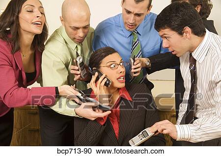 Overwhelmed businesswoman surrounded by co-workers View Large Photo Image Stock Image - Overwhelmed businesswoman surrounded by co-workers. Fotosearch