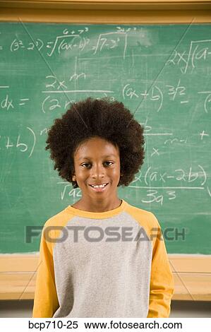 Portrait of boy in front of math on blackboard View Large Photo Image Stock Photography - Portrait of boy in front of math on blackboard. Fotosearch