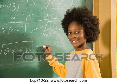 Portrait of boy writing on blackboard View Large Photo Image Stock Image - Portrait of boy writing on blackboard. Fotosearch