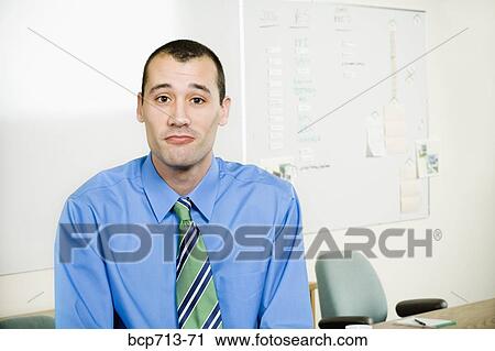 Stock Image - Portrait of businessman in office. Fotosearch