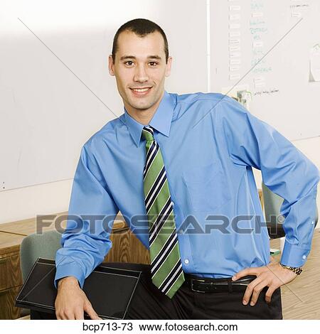 Portrait of businessman in office View Large Photo Image Stock Image - Portrait of businessman in office. Fotosearch