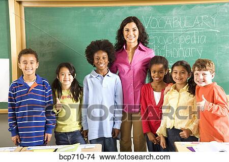 Portrait of female teacher and students in classroom View Large Photo Image Picture - Portrait of female teacher and students in classroom. Fotosearch