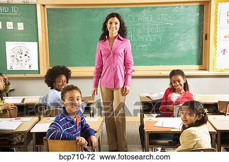 Portrait of female teacher and students in classroom View Large Photo Image Stock Image - Portrait of female teacher and students in classroom. Fotosearch