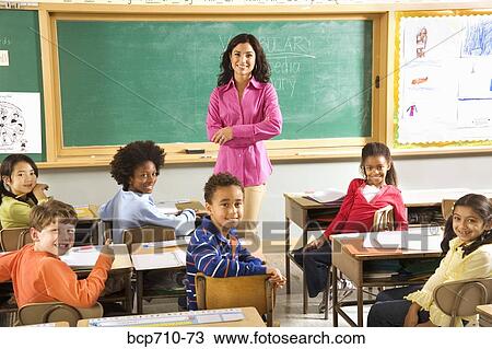 Portrait of female teacher and students in classroom View Large Photo Image Stock Image - Portrait of female teacher and students in classroom. Fotosearch