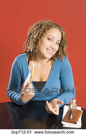 Portrait of woman at desk with mail View Large Photo Image Stock Image - Portrait of woman at desk with mail. Fotosearch