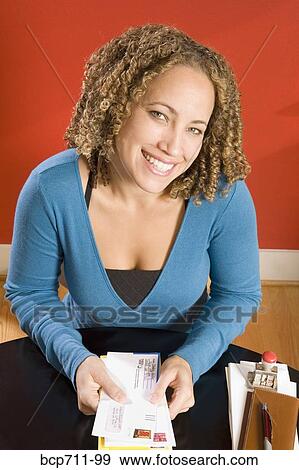 Portrait of woman at desk with mail View Large Photo Image Stock Photo - Portrait of woman at desk with mail. Fotosearch