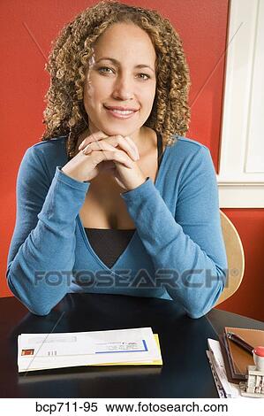 Portrait of woman at desk with mail View Large Photo Image Stock Photography - Portrait of woman at desk with mail. Fotosearch