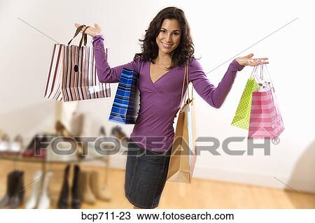 Portrait of woman holding shopping bags View Large Photo Image Stock Image - Portrait of woman holding shopping bags. Fotosearch