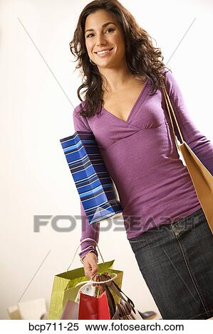 Portrait of woman holding shopping bags View Large Photo Image Stock Photography - Portrait of woman holding shopping bags. Fotosearch