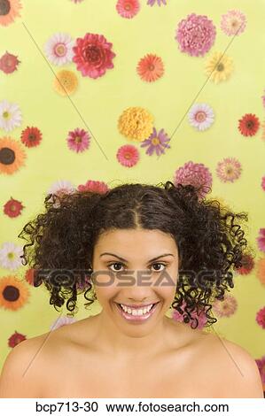 Portrait of woman in front of flower background View Large Photo Image Stock Image - Portrait of woman in front of flower background. Fotosearch