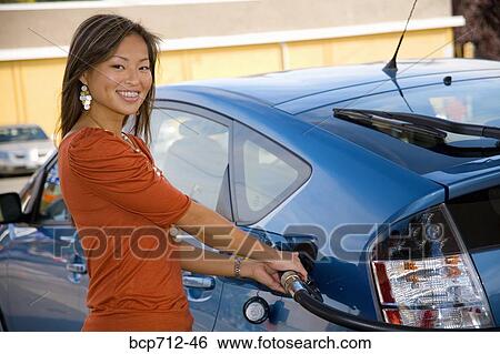 Portrait of woman pumping gas View Large Photo Image Stock Photograph - Portrait of woman pumping gas. Fotosearch