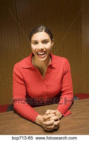 Portrait of woman with hands clasped at table View Large Photo Image Stock Photography - Portrait of woman with hands clasped at table. Fotosearch
