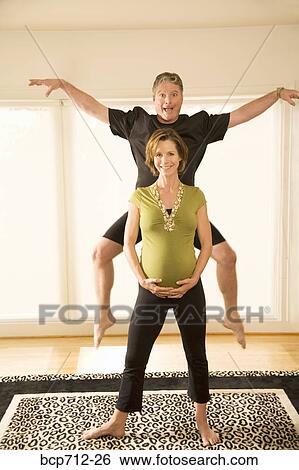 Stock Photograph - Pregnant couple acting silly. Fotosearch
