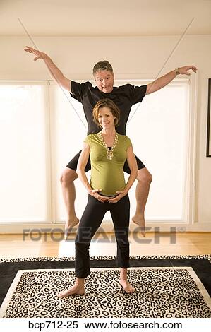 Pregnant couple acting silly View Large Photo Image Stock Photography - Pregnant couple acting silly. Fotosearch