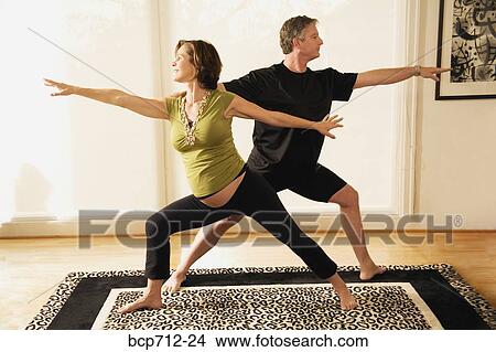 Pregnant couple practicing yoga View Large Photo Image Picture - Pregnant couple practicing yoga. Fotosearch
