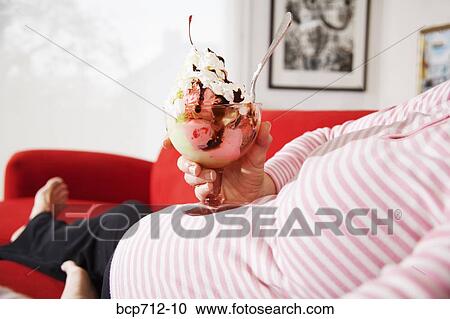 Pregnant woman holding ice cream sundae View Large Photo Image Stock Image - Pregnant woman holding ice cream sundae. Fotosearch