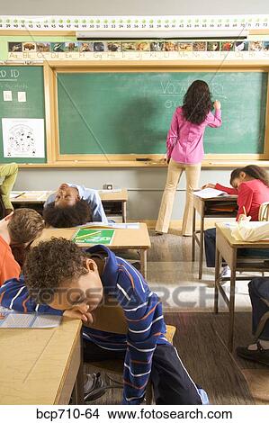 Students sleeping while teacher writes on blackboard View Large Photo Image Picture - Students sleeping while teacher writes on blackboard. Fotosearch