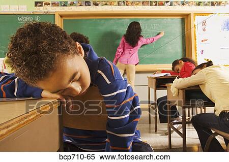 Students sleeping while teacher writes on blackboard View Large Photo Image Stock Photography - Students sleeping while teacher writes on blackboard. Fotosearch