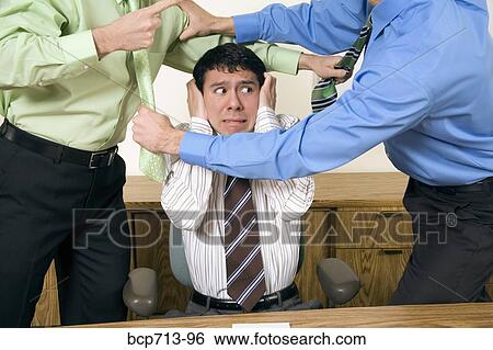 Two businessmen fighting above co-worker View Large Photo Image Stock Photograph - Two businessmen fighting above co-worker. Fotosearch