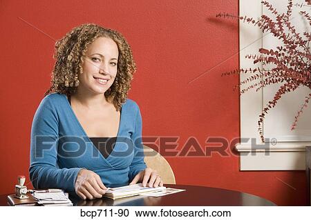 Woman affixing stamp to envelope View Large Photo Image Stock Image - Woman affixing stamp to envelope. Fotosearch