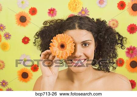 Woman holding flower over eye View Large Photo Image Stock Photograph - Woman holding flower over eye. Fotosearch