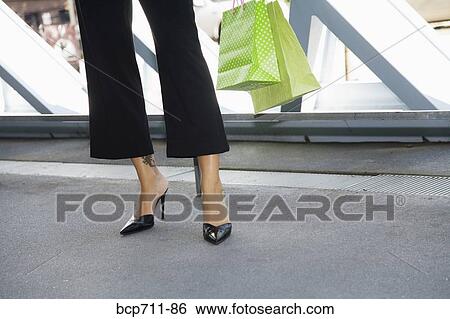 Woman holding shopping bags View Large Photo Image Stock Photograph - Woman holding shopping bags. Fotosearch