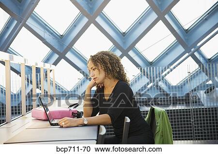 Woman looking at laptop View Large Photo Image Stock Image - Woman looking at laptop. Fotosearch