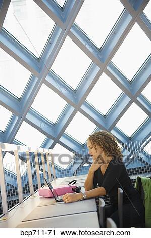 Woman looking at laptop View Large Photo Image Stock Image - Woman looking at laptop. Fotosearch