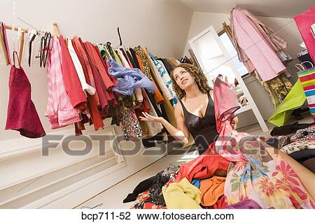 Woman looking for something to wear in closet View Large Photo Image Stock Image - Woman looking for something to wear in closet. Fotosearch