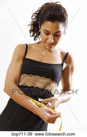 Woman measuring waist View Large Photo Image Stock Photo - Woman measuring waist. Fotosearch
