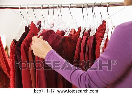 Woman shopping at clothing store View Large Photo Image Stock Photo - Woman shopping at clothing store. Fotosearch