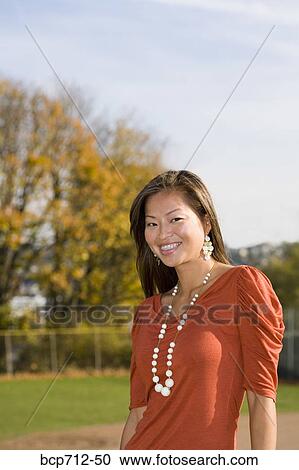 Woman smiling outdoors View Large Photo Image Stock Image - Woman smiling outdoors. Fotosearch
