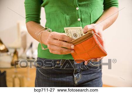 Woman taking money out of wallet View Large Photo Image Stock Photo - Woman taking money out of wallet. Fotosearch