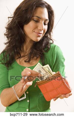 Woman taking money out of wallet View Large Photo Image Stock Photo - Woman taking money out of wallet. Fotosearch