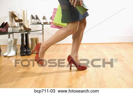Woman trying on shoes in boutique View Large Photo Image Stock Image - Woman trying on shoes in boutique. Fotosearch