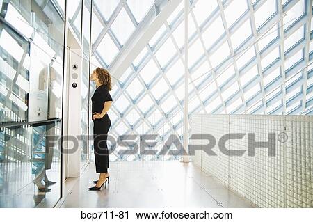 Woman waiting for elevator View Large Photo Image Stock Image - Woman waiting for elevator. Fotosearch