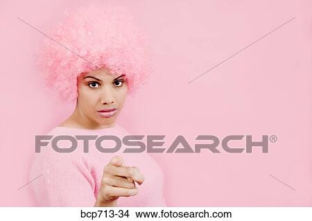 Woman wearing pink wig and pointing View Large Photo Image Picture - Woman wearing pink wig and pointing. Fotosearch