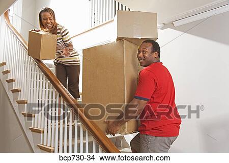 African couple carrying moving boxes View Large Photo Image Picture - African couple carrying moving boxes. Fotosearch