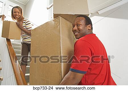 African couple carrying moving boxes View Large Photo Image Picture - African couple carrying moving boxes. Fotosearch