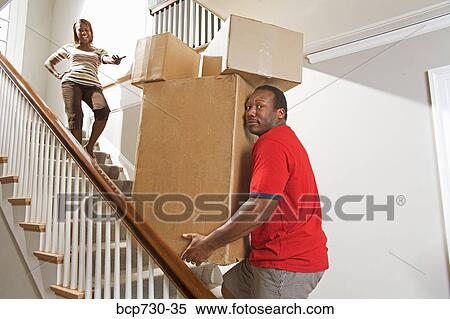 African couple carrying moving boxes View Large Photo Image Stock Photography - African couple carrying moving boxes. Fotosearch