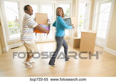 African couple carrying moving boxes View Large Photo Image Stock Photography - African couple carrying moving boxes. Fotosearch