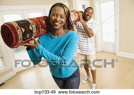 African couple carrying rug View Large Photo Image Stock Photo - African couple carrying rug. Fotosearch