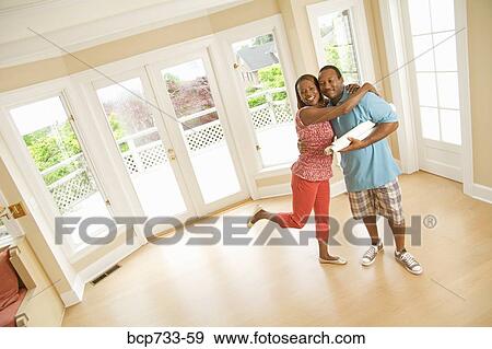 African couple hugging in new house View Large Photo Image Stock Photo - African couple hugging in new house. Fotosearch